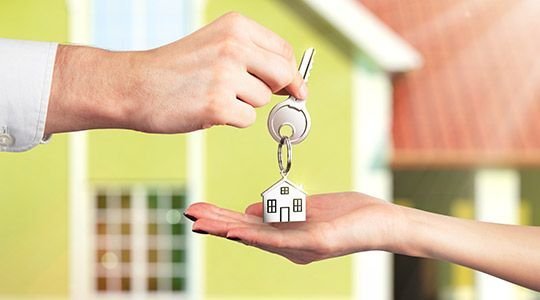 SHOKO assisting an American buyer by handing over house keys after purchasing property in France