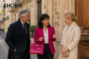 SHOKO in quiet conversation with an ultra-high-net-worth couple on a discreet residential street in the 7th arrondissement