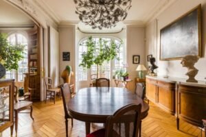 SHOKO examining carved woodwork detail in an exceptional Paris Haussmann apartment