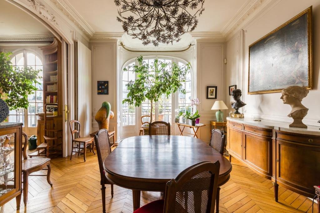SHOKO examining carved woodwork detail in an exceptional Paris Haussmann apartment